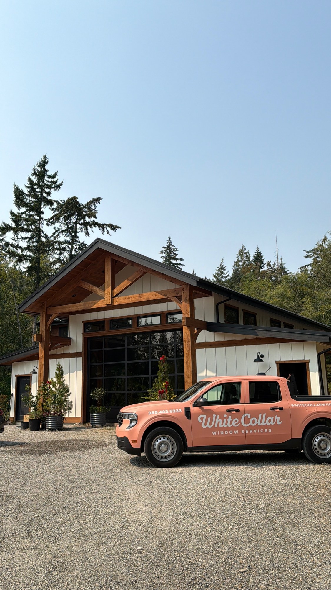 White Collar Windows truck outside a timber-framed home